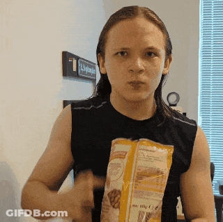 Man In Black Tank Top Holding Food Bag GIF