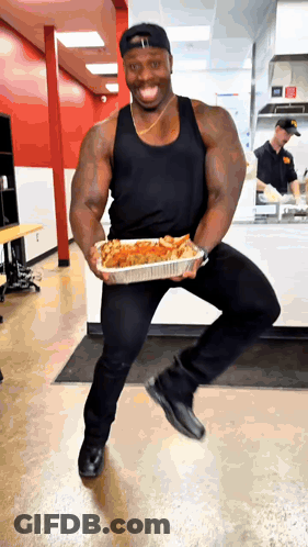Man In Black Tank Top Holding Food Container GIF