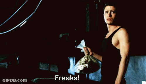 Man In Black Tank Top Holding Freaks Bag GIF