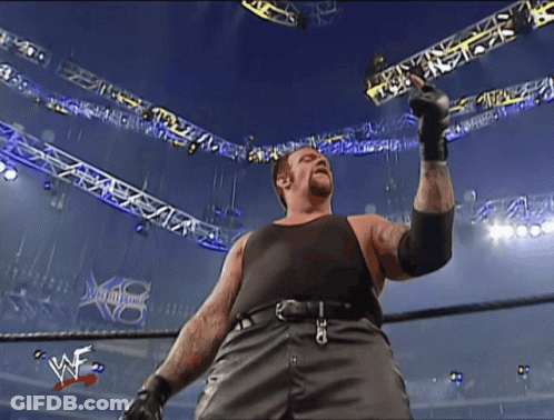 Man In Black Tank Top In Wrestling Ring GIF