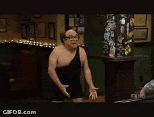Man In Black Tank Top Next To Man In Gray Hoodie GIF