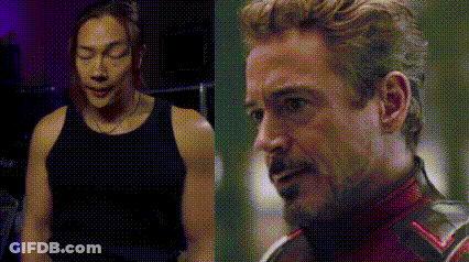 Man In Black Tank Top Next To Man In Red Suit GIF