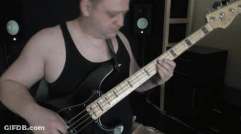 Man In Black Tank Top Playing Guitar GIF