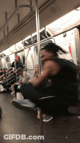 Man In Black Tank Top Riding Subway Train GIF