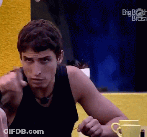 Man In Black Tank Top Sitting At Table With Two Coffee Cups And Big Brother Logo GIF