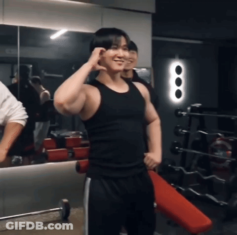 Man In Black Tank Top Smiling In Gym GIF