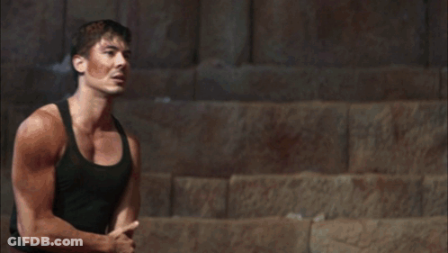Man In Black Tank Top Standing Before Mountain GIF