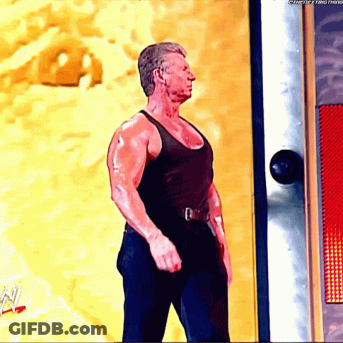 Man In Black Tank Top Standing In Front Of Door Saying Thenextthing GIF