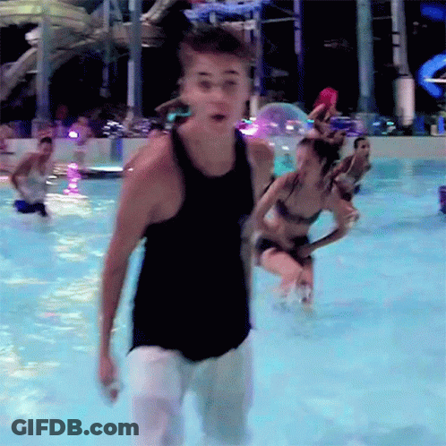 Man In Black Tank Top Standing In Water GIF