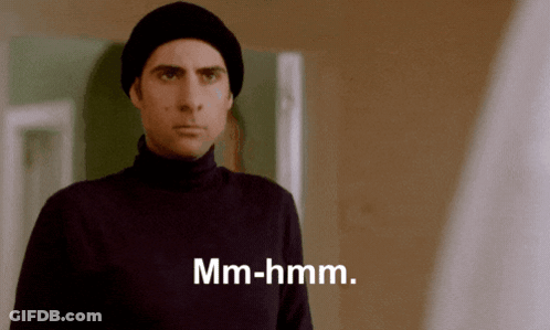 Man In Black Turtleneck And Beanie Says Mm-Hmm GIF