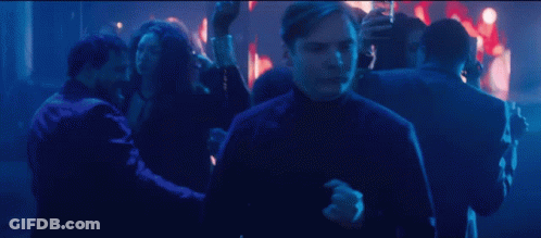 Man In Black Turtleneck Dancing In Crowd GIF