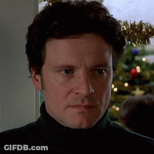 Man In Black Turtleneck Looking At Camera GIF