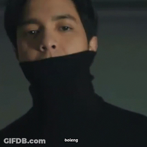 Man In Black Turtleneck Looking At Camera GIF