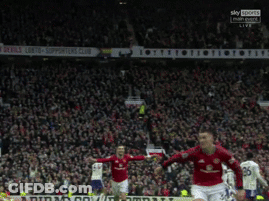 Man In Black Turtleneck Looks At Camera GIF