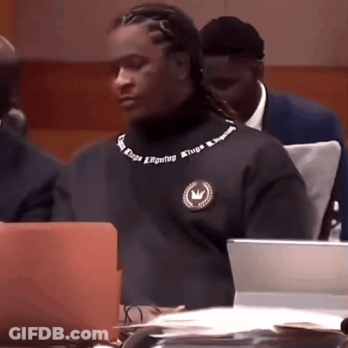 Man In Black Turtleneck With Atripa On Neck GIF