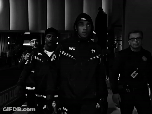 Man In Black UFC Jacket Walking With Security Guard GIF