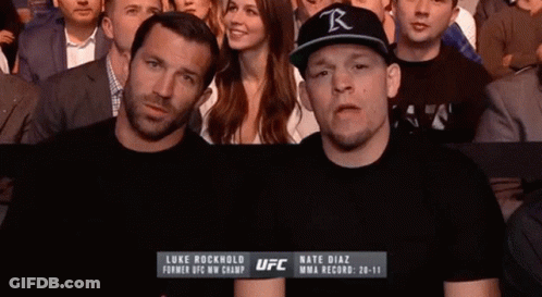 Man In Black UFC Shirt Standing Next To Another Man GIF