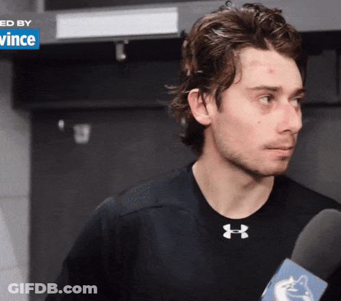 Man In Black Under Armour Shirt Holding Microphone GIF