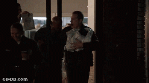 Man In Black Uniform Holding Bag Of Papers GIF