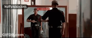 Man In Black Uniform Looking In Mirror GIF
