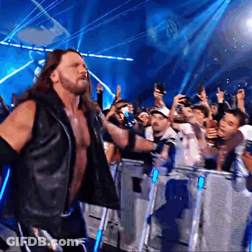 Man In Black Vest In Front Of Crowd GIF