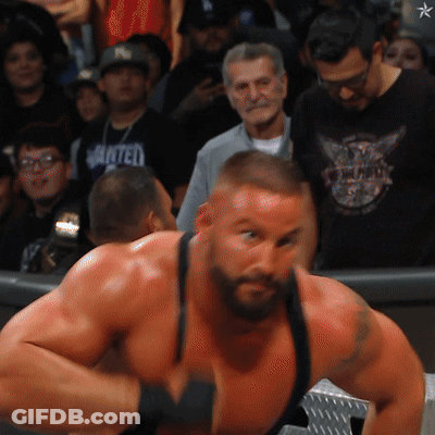 Man In Black Wanted Shirt Facing Crowd GIF