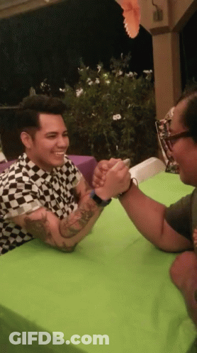 Man In Black White Checkered Shirt Arm Wrestling GIF
