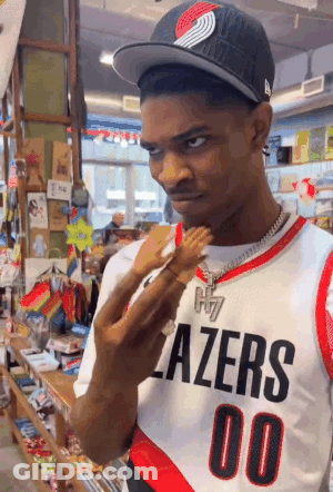 Man In Blazers Jersey Holding Barbie Doll GIF