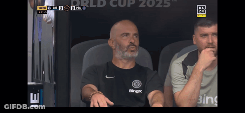 Man In Blingx Shirt Sitting In Stadium GIF