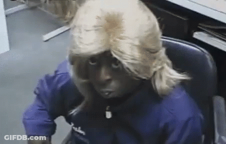 Man In Blonde Wig And Blue Falcon Shirt GIF