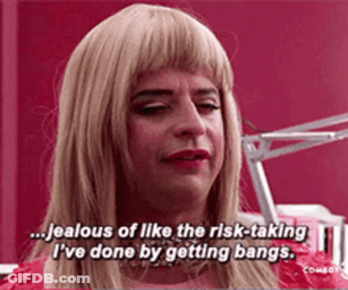 Man In Blonde Wig Talking About Bangs GIF