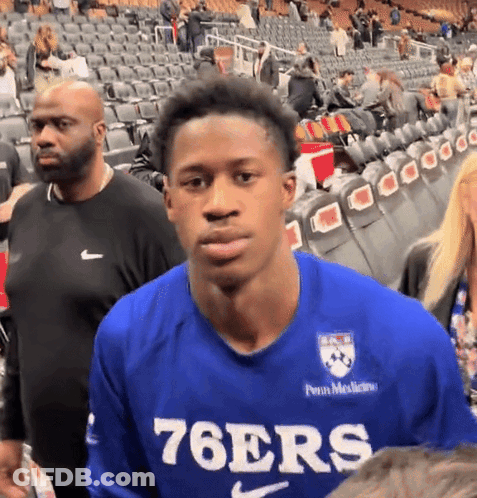 Man In Blue 76Ers Shirt In Crowded Stadium GIF