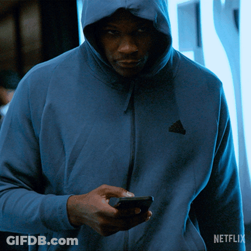Man In Blue Adidas Hoodie Looking At Phone GIF