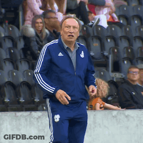 Man In Blue Adidas Jacket Standing In Stadium GIF
