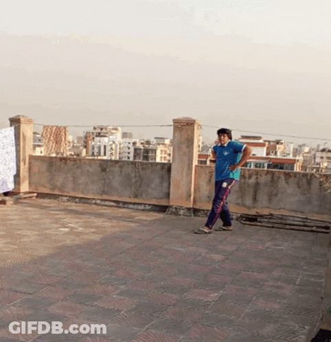 Man In Blue Adidas Shirt On Rooftop GIF