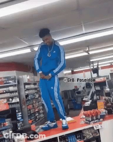 Man In Blue Adidas Tracksuit Standing In Store GIF