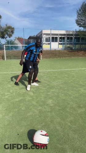 Man In Blue And Black Jersey Kicking Ball GIF