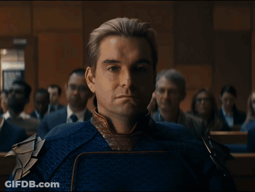 Man In Blue And Gold Costume Sitting In Room GIF