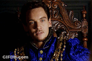 Man In Blue And Gold Costume Sitting In Wooden Chair GIF