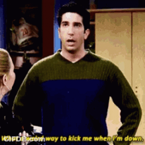 Man In Blue And Green Sweater Talking To Woman GIF