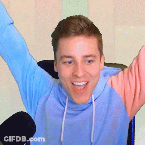 Man In Blue And Pink Hoodie Smiling With Arms Outstretched GIF