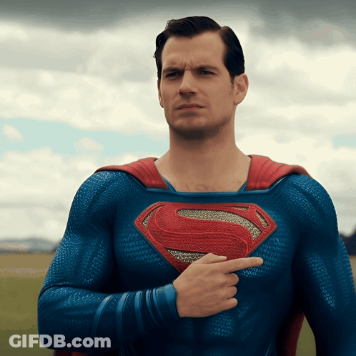 Man In Blue And Red Superman Costume Pointing To Chest GIF