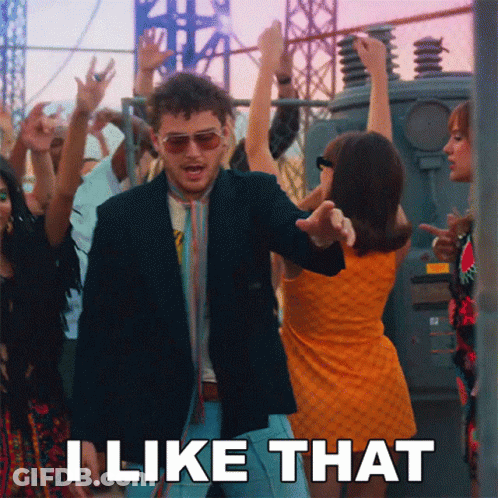 Man In Blue And Tan Varsity Jacket Looking At Cell Phone GIF