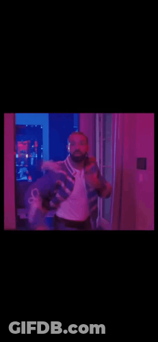 Man In Blue And White Jacket Dancing In Purple Lights GIF