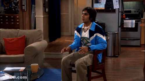 Man In Blue And White Jacket Sitting In Chair GIF