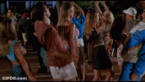 Man In Blue And White Jacket Surrounded By Women GIF