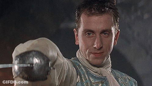 Man In Blue And White Outfit Holding Sword GIF