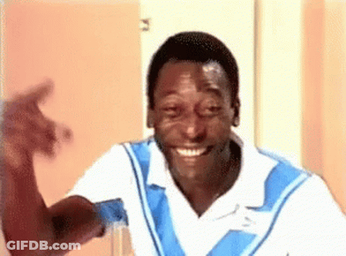 Man In Blue And White Shirt Smiling And Waving GIF