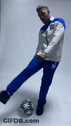 Man In Blue And White Soccer Uniform Kicking Ball GIF