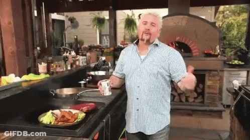 Man In Blue And White Striped Shirt Cooking In Kitchen GIF